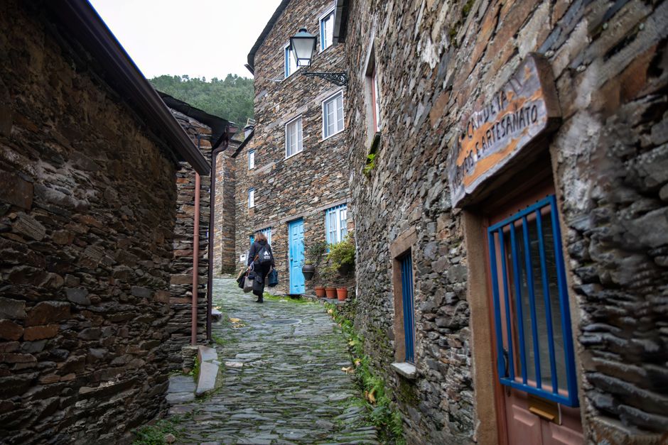 Captivating view of a cobblestone street and traditional stone houses in Piodão, Portugal.