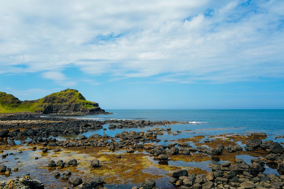Beautiful view of the rocky coastline and sky at Giant's Causeway, Northern Ireland.