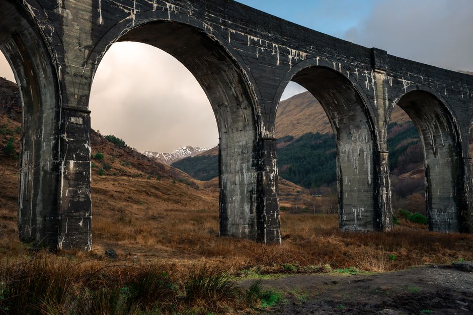 Majestic view of the Glenfinnan Viaduct in the scenic Scottish Highlands, showcasing architectural beauty.