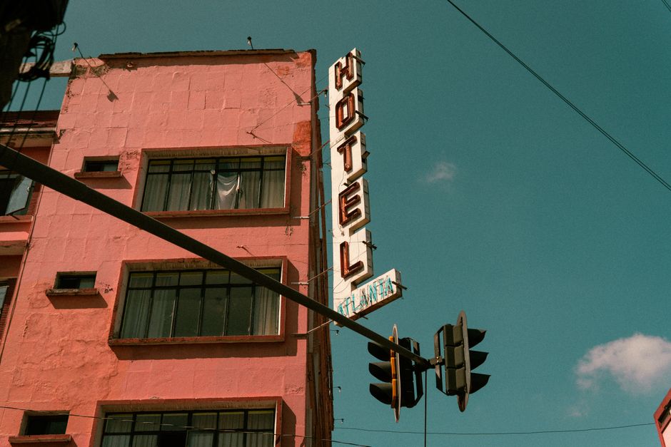 Vintage hotel sign on a pink building in Ciudad de México, showcasing urban architecture.