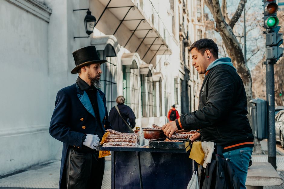 A street vendor in historic attire selling goods in downtown Buenos Aires, Argentina.