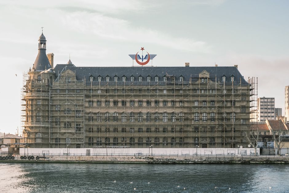 Scaffolding on a historic waterfront building under renovation.