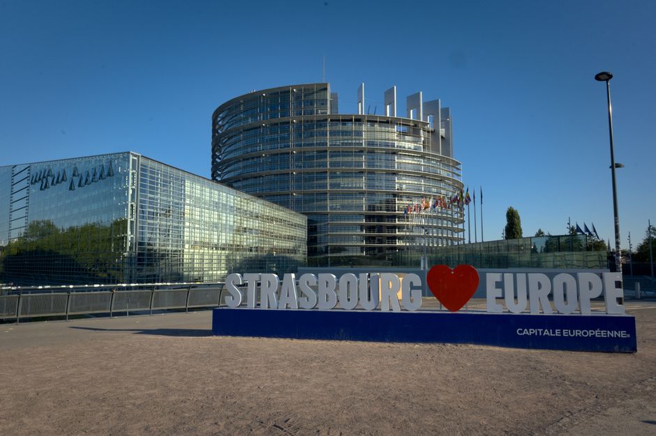 European Parliament building in Strasbourg with a famous sign in front.