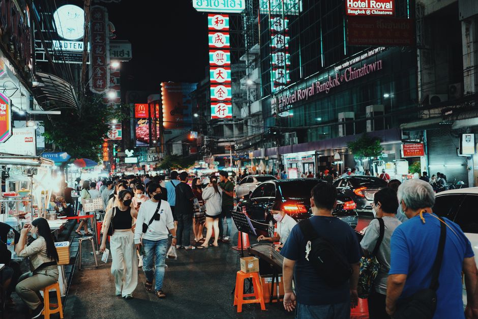 Discover the vibrant night scene in Bangkok's bustling Chinatown with street food and neon lights.