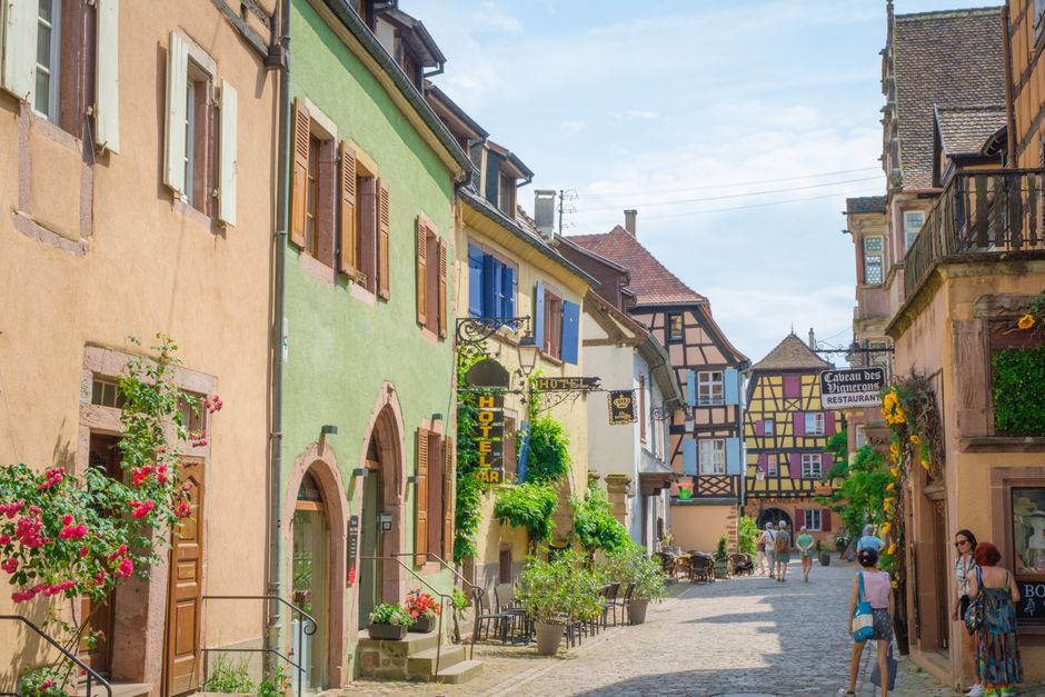 Picturesque street in Alsace, France showcasing vibrant facades and classic European architecture on a sunny day.
