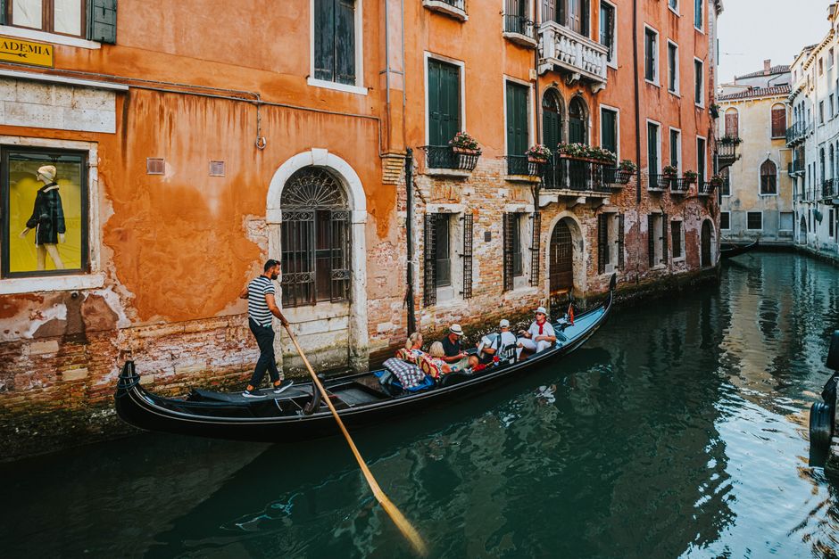 Charming gondola ride on the canals of Venice, showcasing vibrant architecture and unique local culture.